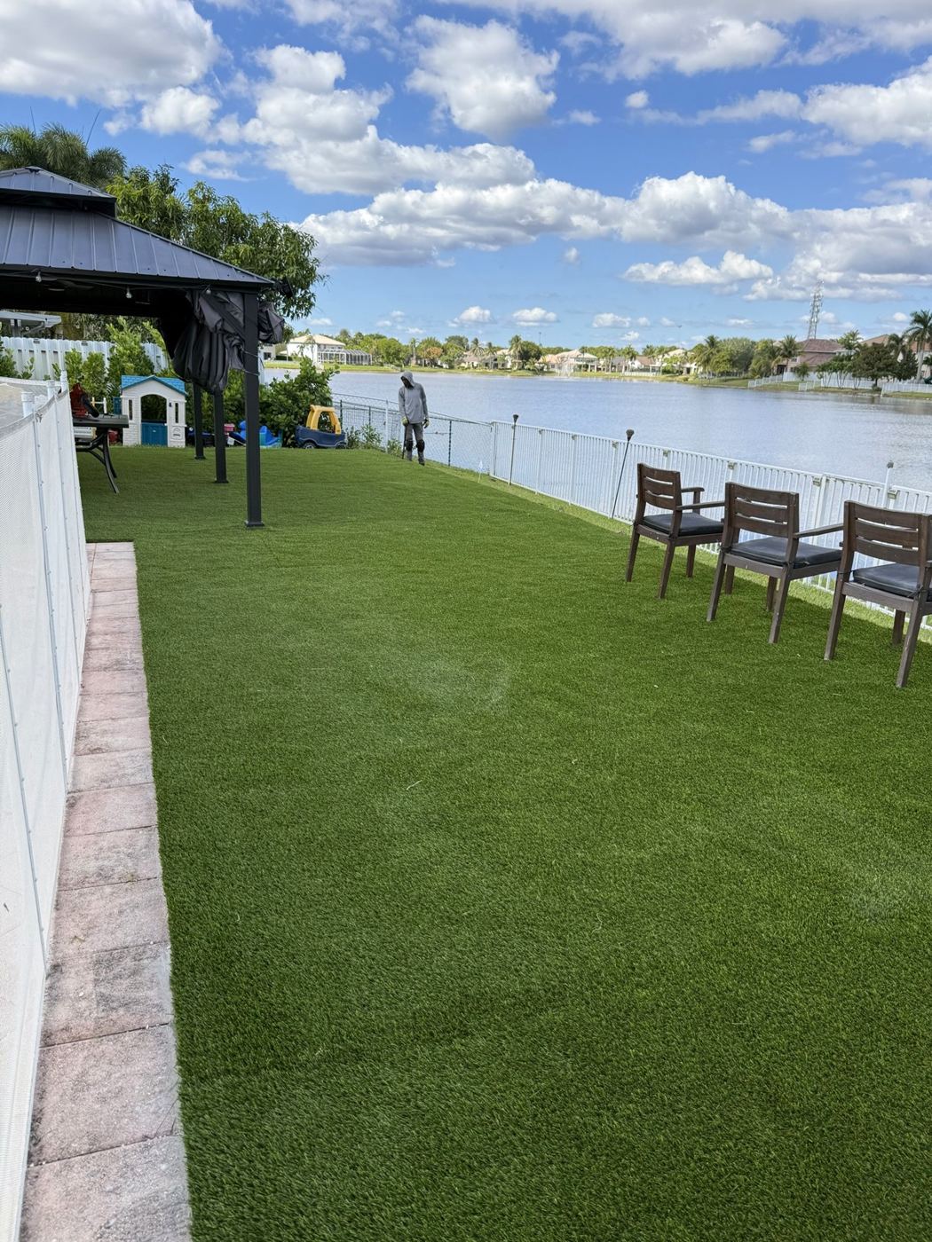 Patio frente al lago con grama artificial